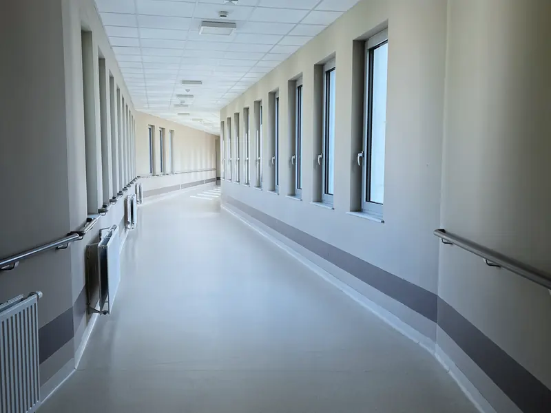 An empty, well lit hospital corridor